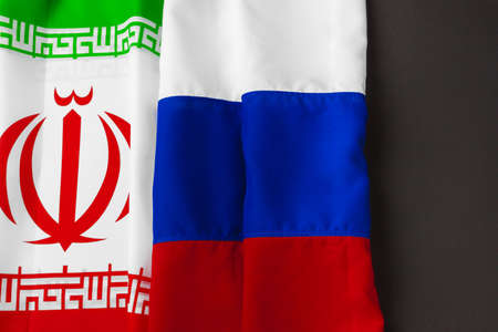 Flag of Iran and Russia together on black backgroundの写真素材