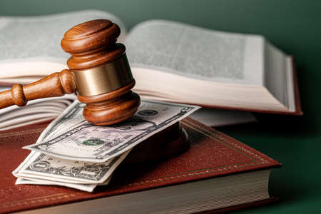 Close up of a brown wooden gavel and book