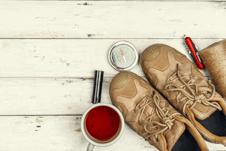 Hiking boots, compass and knife. Hiking outdoor equipment
