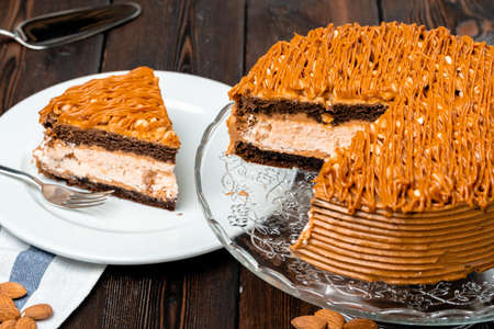Plate with delicious caramel cake close up