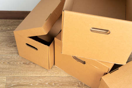 Group of brown carton boxes on wooden floorの写真素材