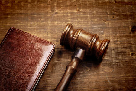 Image of wooden judge hammer on notepad