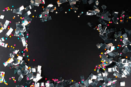 Silver sparkles tinsel on a black background
