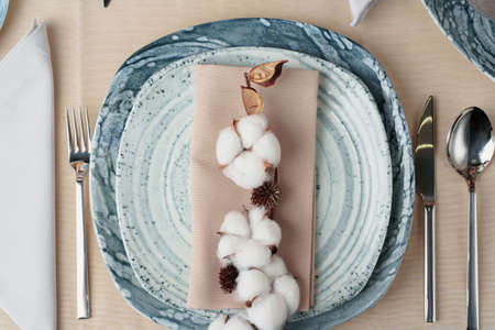 Beautiful table setting decorated with cotton buds