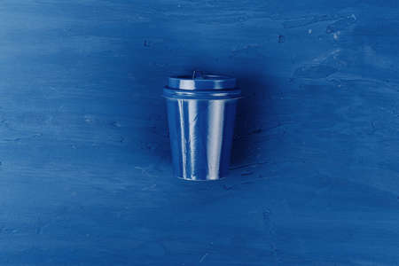 Top view of a takeaway coffee cup on classic blue backgroundの写真素材