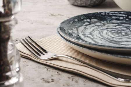 Ceramic stylish tableware set on grey background