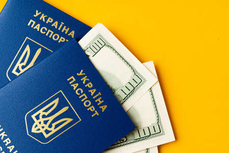 Ukrainian passport with heap of american dollars insideの写真素材