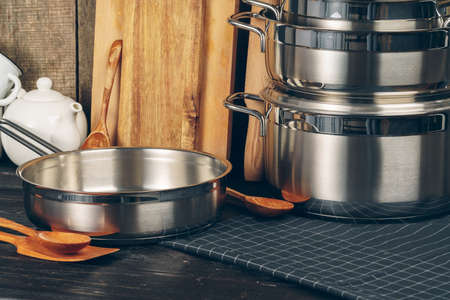 Set of stainless steel saucepans in a kitchenの写真素材