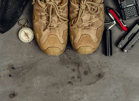Hiking boots, compass and knife. Hiking outdoor equipment