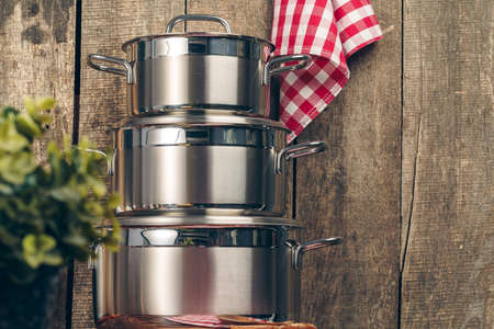 Set of stainless steel saucepans in a kitchenの写真素材