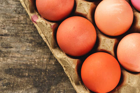 Traditional Christian eastertime, painted eggs in egg box.