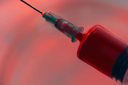 Syringe with blood inside close up photoの写真素材