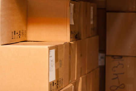 Modern warehouse shelves with pile of cardboard boxesの写真素材