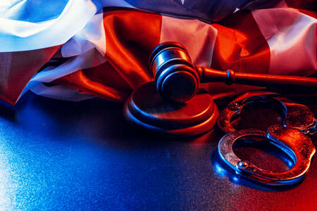 Gavel, handcuffs and american flag on dark backgroundの写真素材