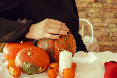 Cropped image of a woman holding a pumpkin in her handsの写真素材