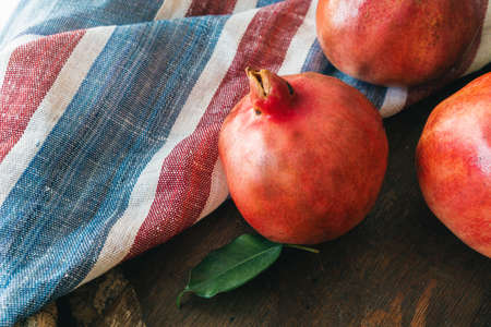 Pile of ripe pomegranate on wooden backgfroundの写真素材