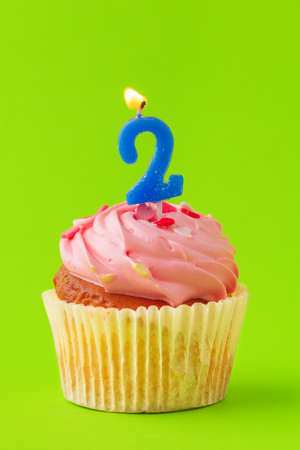 Delicious cupcakes with candles on a colored background. Festive background, birthdayの写真素材