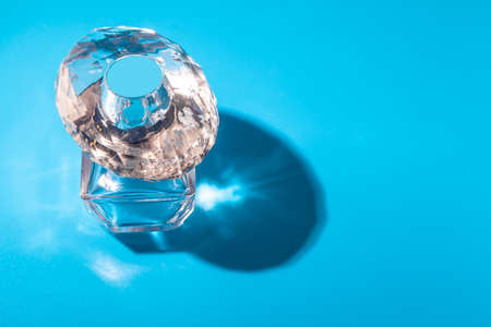 perfume glass bottle on light blue background. Eau de toiletteの写真素材
