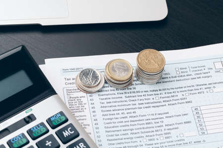 avings, finances, economy and home concept - close up of calculator counting money and making notes...