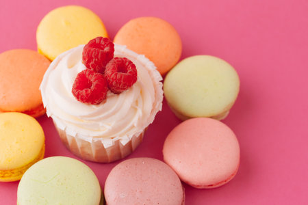 Yummy sweet cupcakes on light pink backgroundの写真素材