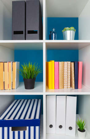 White office shelves with different stationery, close upの写真素材