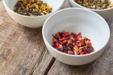 Aromatic dry tea in bowls on wooden backgroundの写真素材