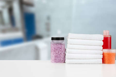 Various spa beauty threatment products and towels against blurred background