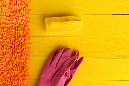 Household cleaning brush on yellow wooden background