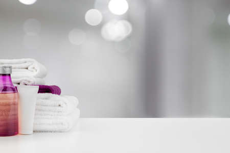 Spa still life with towels and skincare cosmetics against blurred background, close upの写真素材