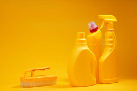 House cleaning detergent bottles on a yellow background, copy spaceの写真素材
