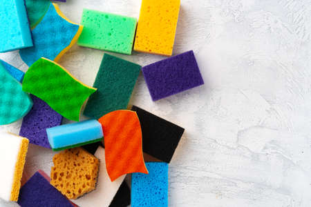 Pile of colorful cleaning sponges on gray background, top viewの写真素材
