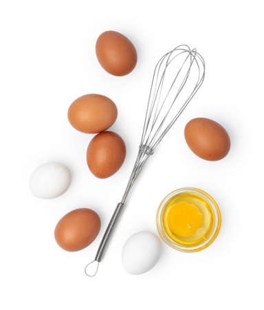 Fresh eggs with whisk isolated on white background