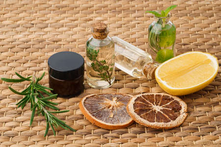 Bottle with essential oil on wooden background