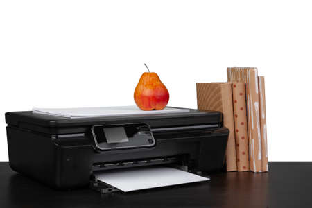 Working table with printer and stacked books on white backgroundの写真素材