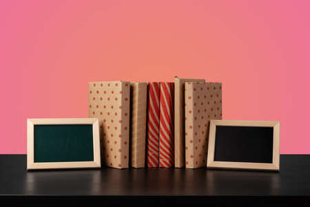 Education concept with stack of books on a table against colored background.の写真素材
