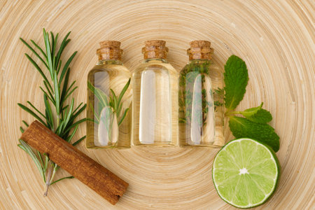 Bottles with massage oils on bamboo stick straw matの写真素材