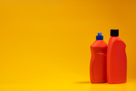 House cleaning detergent bottles on a yellow backgroundの写真素材