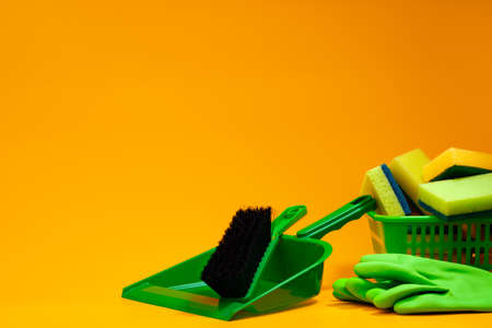 Home cleaning tools on yellow studio backgroundの写真素材