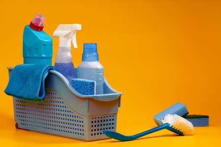 Home cleaning tools on yellow studio backgroundの写真素材