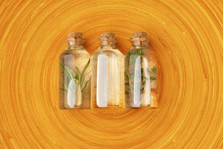 Bottles with massage oils on bamboo stick straw matの写真素材