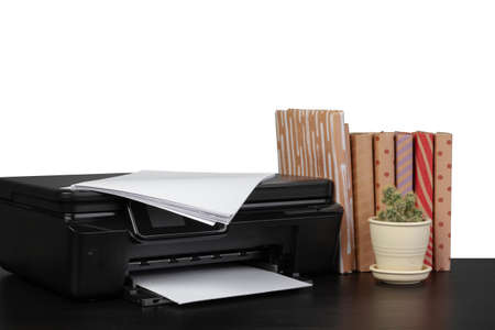 Office table with laser printer and books against white backgroundの写真素材