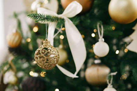 Christmas tree decorated with white and golden balls close up.の写真素材