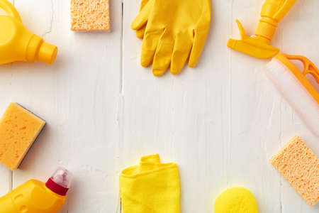 Home cleaning supplies on white wooden background, top viewの写真素材