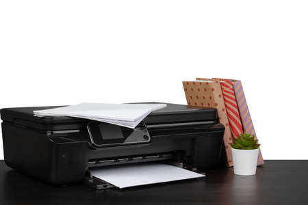 Working table with printer and stacked books on white abckgroundの写真素材