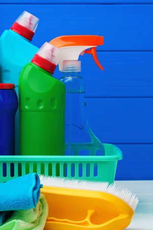 Various cleaning items against blue wooden backgroundの写真素材