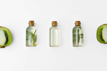Bottle with essential oil and green leaf isolated on white backgroundの写真素材