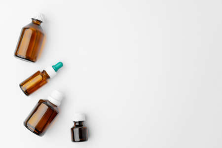 Small glass bottles with medication on white background flat layの写真素材
