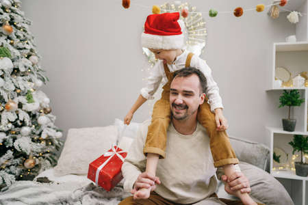 Young dad and his son celebrate christmas togetherの写真素材