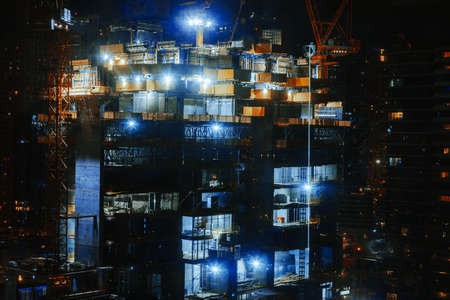Building at construction site at night time in Dubaiの写真素材