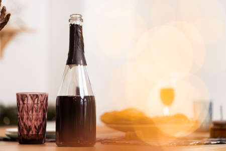 Red wine bottle and cup on wooden tableの写真素材